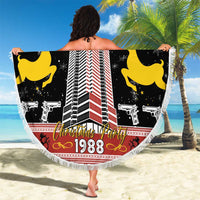 Round beach blanket with fringed edge, black holiday graphic featuring building, reindeer, and 1988