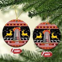 Black ceramic oval ornament with gold loops; 1988 skyline tower on front and back