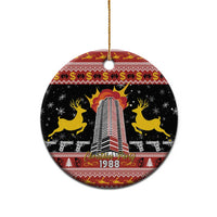 Black ceramic hanging ornament with gold loop showing 1988 skyline tower and yellow horses