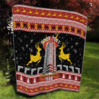 Personalized black quilt with festive red border, yellow reindeer, rifles, and 1988
