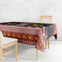 Black and red Christmas tablecloth with zigzag border and deer motif, hanging at table edge