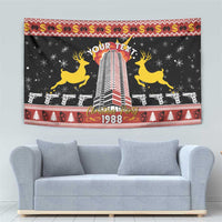 Black Christmas tapestry with tower graphic, yellow reindeer, red festive border and 1988