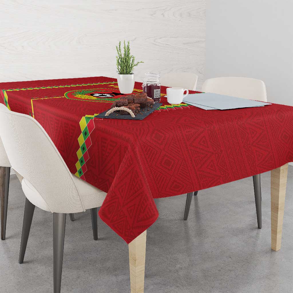 Red football tablecloth with patterned surface and green-and-yellow border corner drop