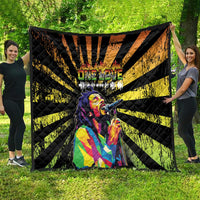 Black and yellow quilt blanket with diagonal sunburst stripes and central portrait artwork.