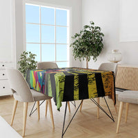 Rectangle tablecloth on dining table, black base with green and multicolor graphic panels