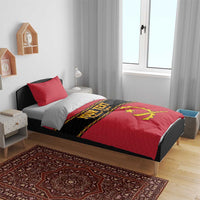 Red duvet and pillow set with black 'YOUR TEXT' band and yellow Angola crest