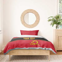 Red bedding set with yellow Angola crest, 'YOUR TEXT' stripe, and gray border trim