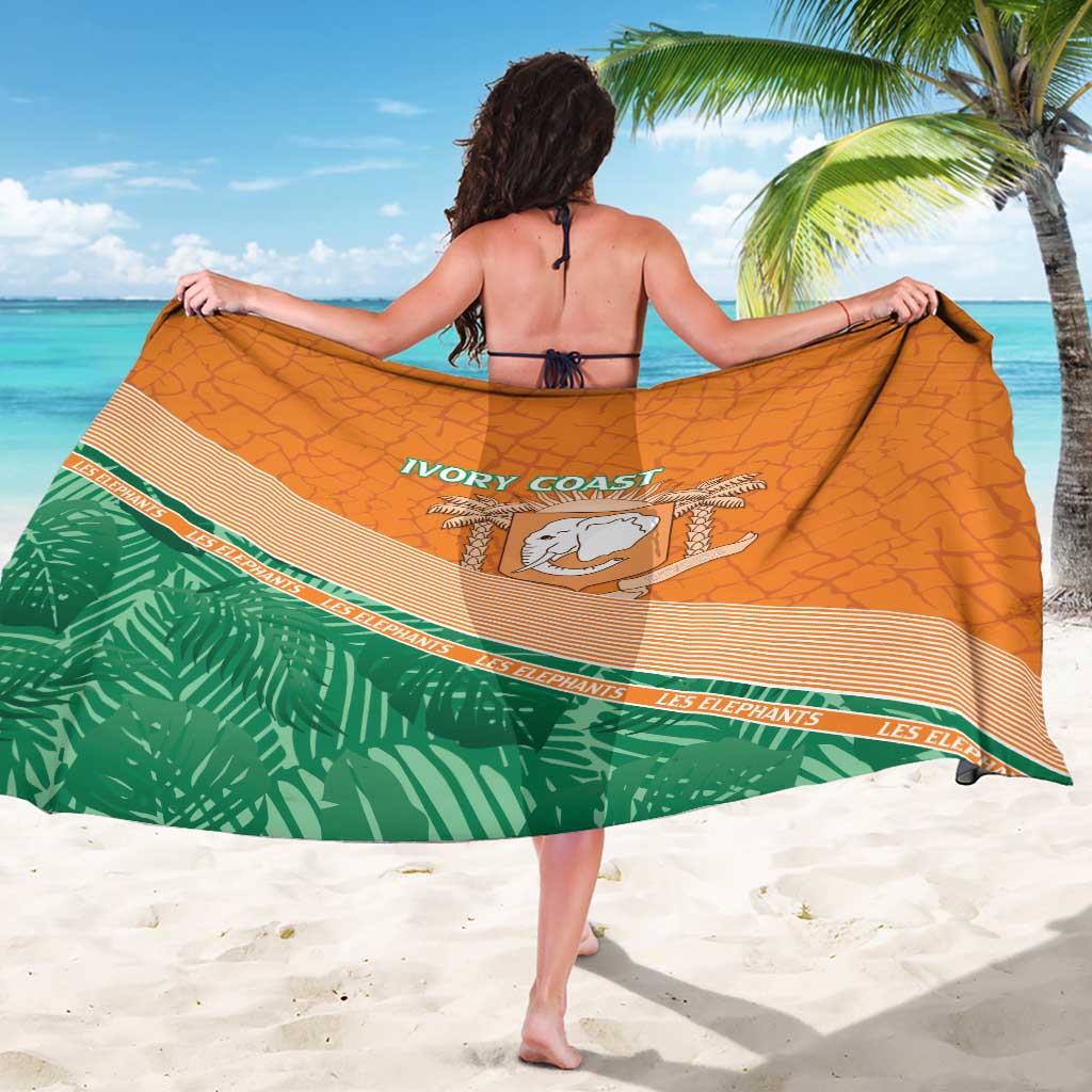 Orange and green elephant sarong with central badge and striped band, worn as wrap.