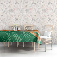 Orange and green tablecloth featuring elephant design and striped trim on dining table