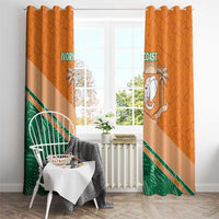 Orange window curtain pair with Ivory Coast elephant crest, green foliage, and striped diagonal band