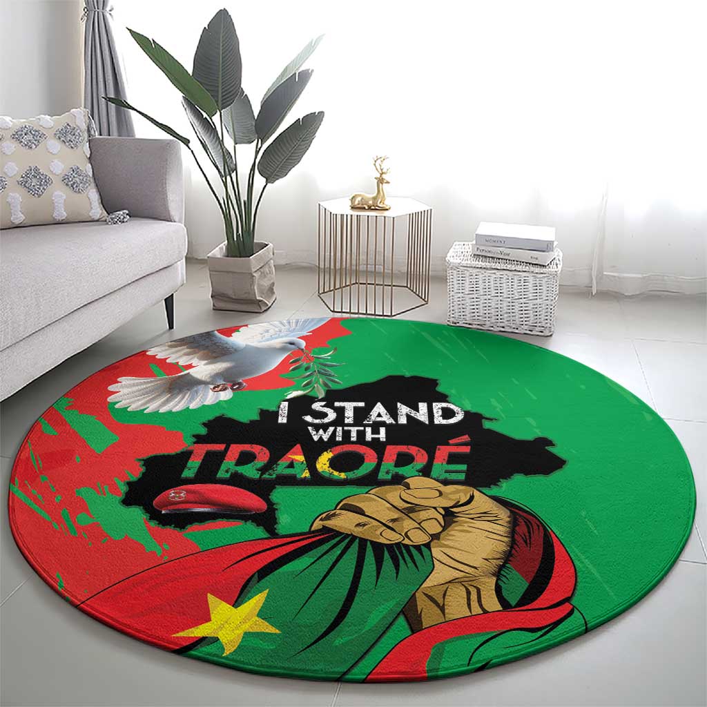 Round green and red carpet with Traore protest graphic and bold text.