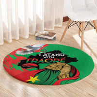 Round green carpet with Traore slogan and Burkina Faso flag graphic