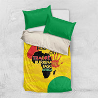 Folded yellow and green graphic bedding set with green pillowcases and duvet cover