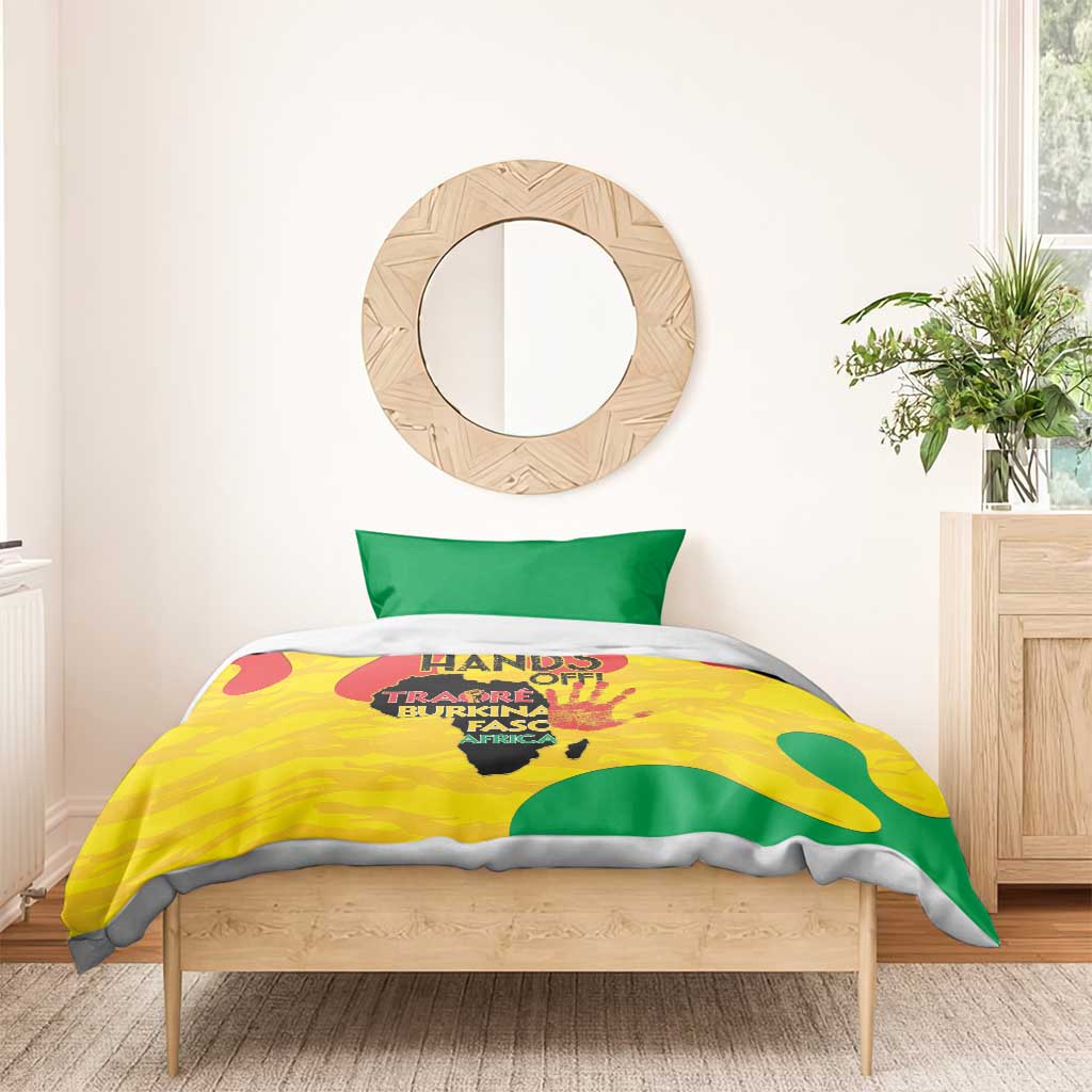 Yellow and green graphic bedding set with two pillowcases on a wooden bed