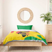 Yellow and green graphic bedding set with two pillowcases on a wooden bed