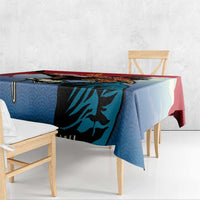 Eagle hunter tablecloth close-up, blue fabric with black eagle graphic and red edge.
