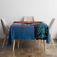 Blue personalised tablecloth with eagle motif and red trim on dining table with chairs.