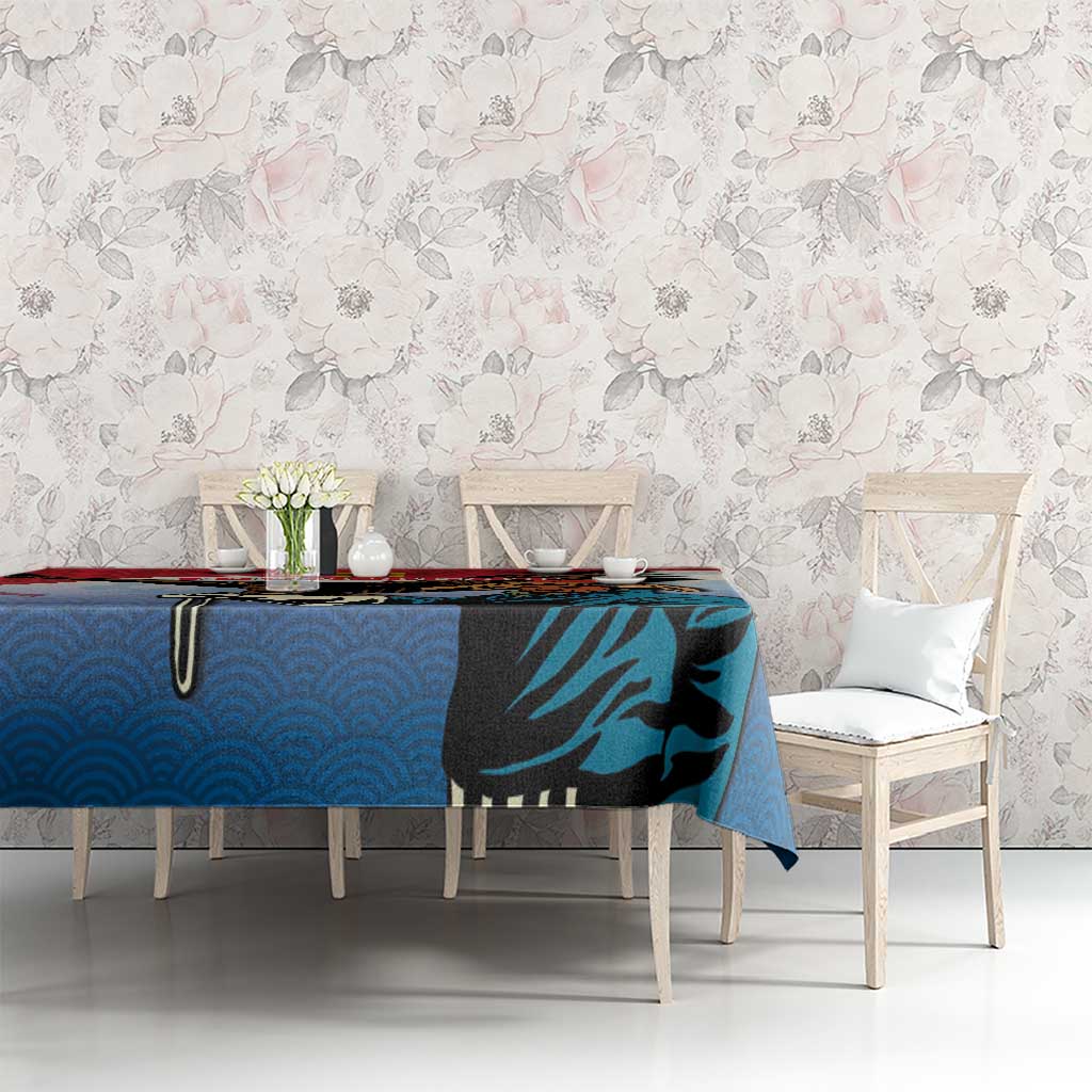 Blue tablecloth with eagle hunter graphic and red trim on dining table with chairs.