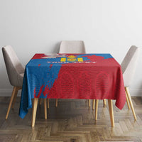 Blue and red tablecloth with emblem artwork on dining table between four chairs