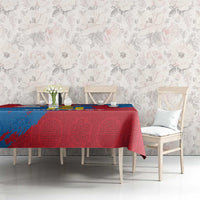 Blue and red patterned tablecloth with coat-of-arms motif on dining table in living room