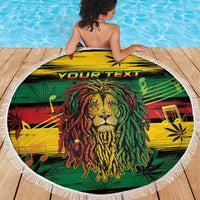 Round beach blanket laid flat, colorful lion face with "YOUR TEXT" and white fringe.