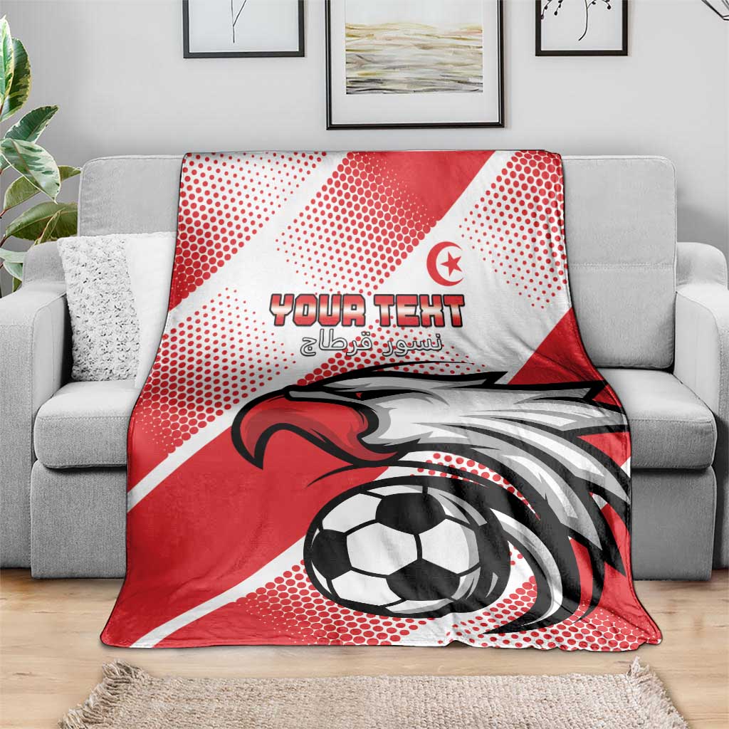 Tunisia football blanket draped on grey sofa, red and white eagle and soccer ball design