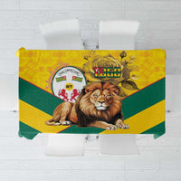 Yellow and green tablecloth with Togo lion and coat of arms graphic, kente pattern border