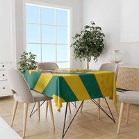 Yellow and green geometric kente pattern tablecloth draped over dining table