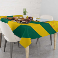 Yellow and green kente pattern tablecloth with diagonal stripes and corner lion graphic