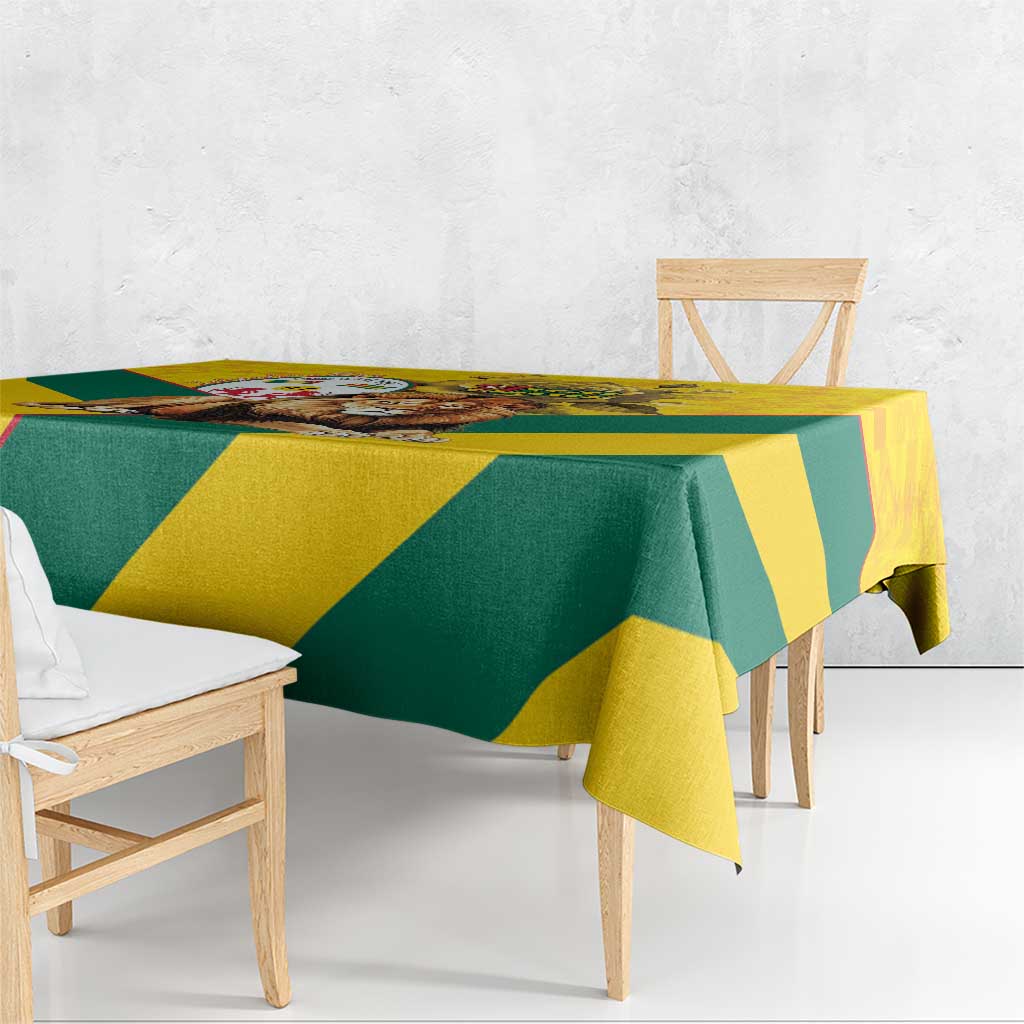 Yellow and green kente pattern tablecloth with triangular blocks, hanging over table edge