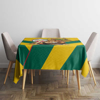 Yellow and green kente pattern tablecloth covering table with chairs