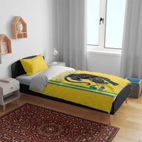 Yellow duvet with panther logo and stripe trim, styled with two matching pillows