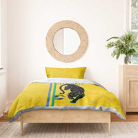 Yellow bedding set with panther and soccer ball print, two pillows on wooden bed