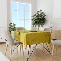 Yellow football tablecloth draped over dining table, featuring black cat graphic and stripes
