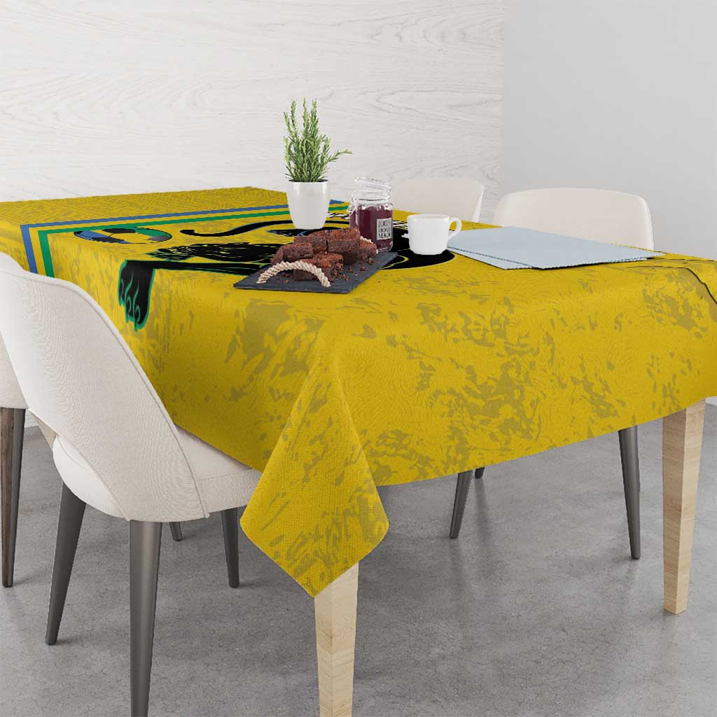 Yellow football tablecloth with black cat print and blue-green stripe along the edge