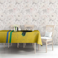 Yellow football tablecloth featuring black cat emblem and blue-green stripe accents on table