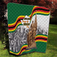 Green and white quilt featuring Zimbabwe Heroes Day logo and bronze memorial statue