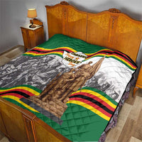 Green quilt with Zimbabwe Heroes Day graphic, wavy flag border, and statue artwork