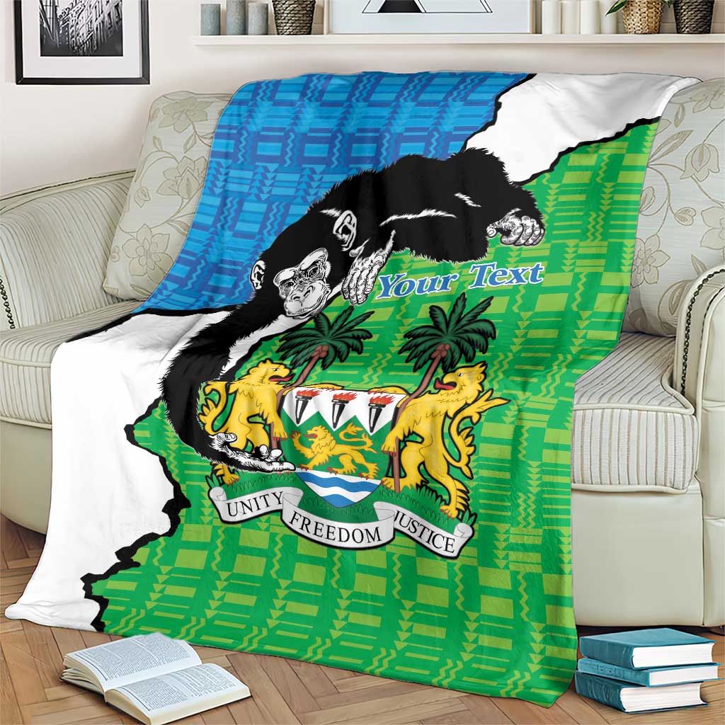 Green and blue Sierra Leone blanket with chimpanzees and coat of arms, spread on sofa