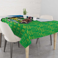 Green personalised tablecloth with coat of arms print and geometric pattern across table surface