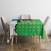 Green personalised tablecloth with Sierra Leone coat of arms and geometric pattern on table