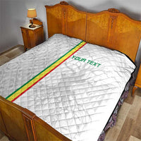 White football quilt with diamond quilting, green-red stripe and 'YOUR TEXT' on bed