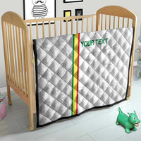 White football quilt with diamond quilting, green-red vertical stripe and 'YOUR TEXT' on crib