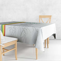 White tablecloth draped on wooden bench-style seating with grey player print
