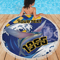 Round beach blanket with fringe, blue-yellow fish flag design and Independence Day lettering.