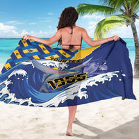 Blue sarong with yellow geometric flag blocks and flying fish, 'YOUR TEXT' on back