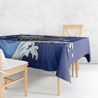 Blue tablecloth with white wave and flying fish design, hanging over bench table edge