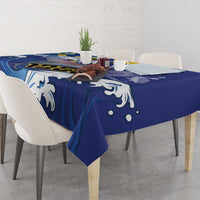 Blue tablecloth with white flying fish and wave pattern, draped over dining table