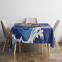 Blue tablecloth with white flying fish and wave pattern, covering a square dining table