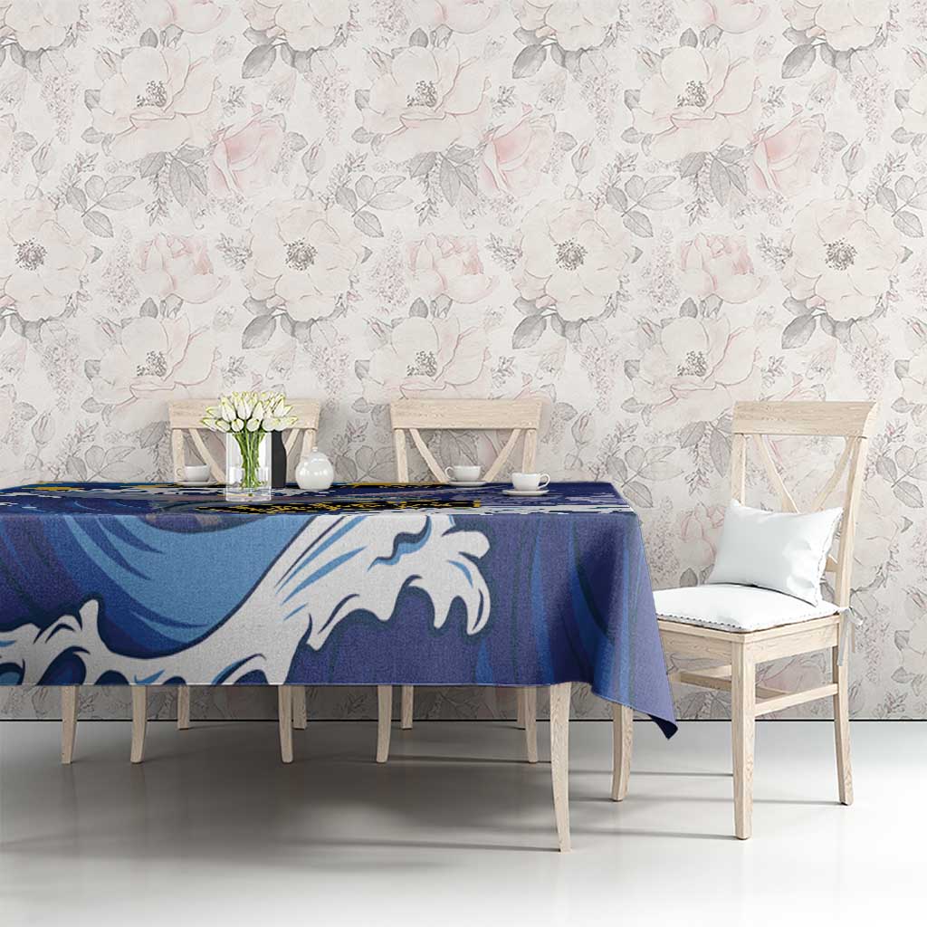Blue tablecloth with white flying fish and wave motifs, spread across dining table